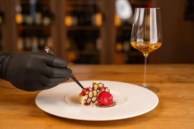 a person holding chopsticks and a bowl of food at Hotel Alpen Tesitin Panorama Wellness Resort in Tesido