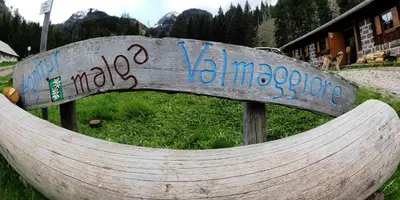 a stone wall with a sign on it at Malga Valmaggiore in Bellamonte