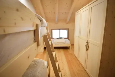 a bedroom with bunk beds in a tiny house at Malga Valmaggiore in Bellamonte