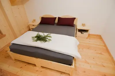 a bedroom with a bed and a table with plants at Malga Valmaggiore in Bellamonte
