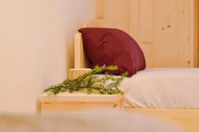 a bed with two pillows on it in a room at Malga Valmaggiore in Bellamonte