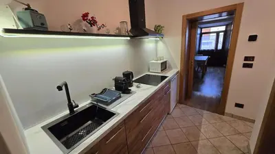 a kitchen with a sink and a counter top at Maison Cavalese - Wild Forest, tranquillità a due passi dal centro in Cavalese
