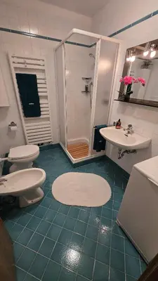 a bathroom with two toilets and a shower and two sinks at Maison Cavalese - Wild Forest, tranquillità a due passi dal centro in Cavalese