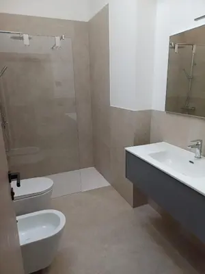 a bathroom with a sink and a toilet and a shower at FIEMME IN VISTA Apartments in Ziano di Fiemme