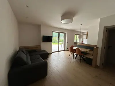 a living room with a couch and a table at FIEMME IN VISTA Apartments in Ziano di Fiemme