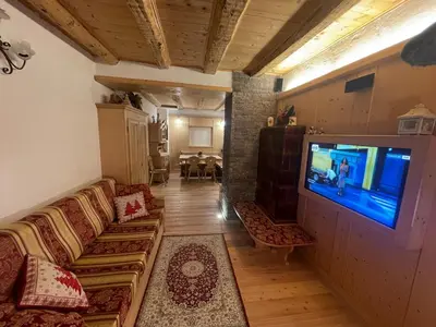 a living room with a couch and a flat screen tv at Rustico NaturaViva in Valfloriana