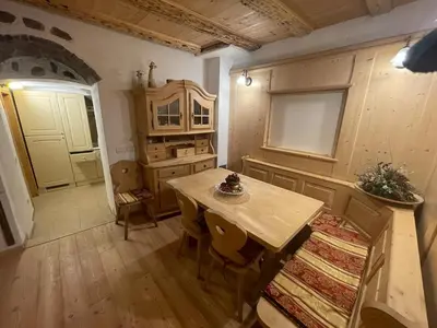 a kitchen with a wooden table and a table and chairs at Rustico NaturaViva in Valfloriana