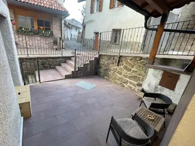 an outdoor patio with chairs and stairs in a building at Rustico NaturaViva in Valfloriana
