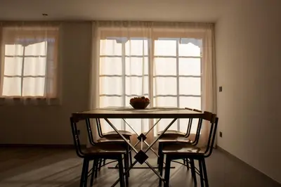 a table with two chairs and a bowl of fruit on top at Villa Moroseta in Tesero