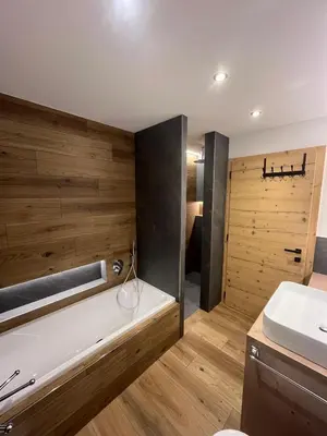 a bathroom with a tub and a sink at Villa Moroseta in Tesero