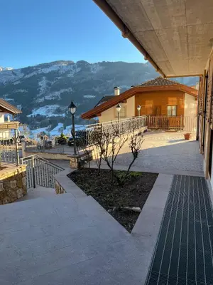 a view of a building with mountains in the background at Villa Moroseta in Tesero