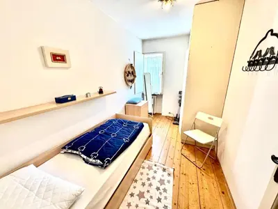 a small room with a bed and a chair at Ca Radiosa - Via Guide Alpine in Cortina dʼAmpezzo