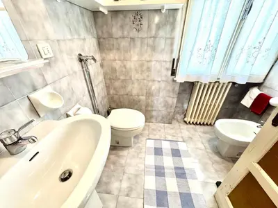a bathroom with a white sink and a toilet at Ca Radiosa - Via Guide Alpine in Cortina dʼAmpezzo