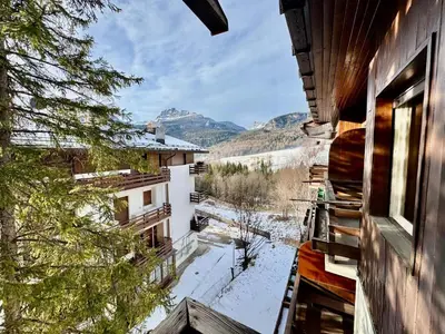 a view from a balcony of a building with snow on the ground at Ca Radiosa - Via Guide Alpine in Cortina dʼAmpezzo