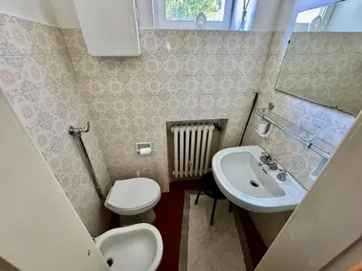 a small bathroom with a sink and a toilet at Villa Augusta-central apartment in Cortina dʼAmpezzo