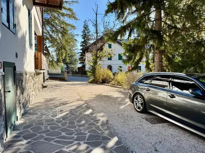 a car parked on the side of a driveway at Villa Augusta-central apartment in Cortina dʼAmpezzo