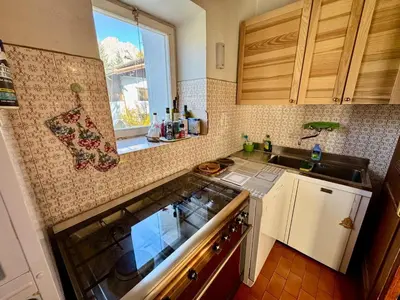 a kitchen with a sink and a counter top at Villa Augusta-central apartment in Cortina dʼAmpezzo
