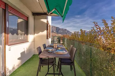 a table and chairs on a balcony with a view at Trilo Ciasa Brìma in Carano