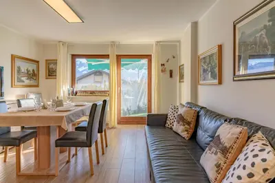 a living room with a couch and a table at Trilo Ciasa Brìma in Carano