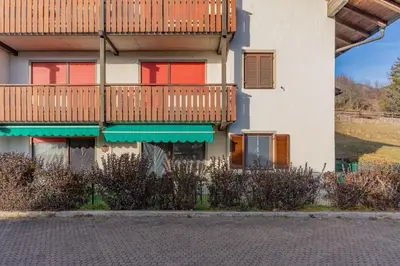 an apartment building with a balcony and a deck at Trilo Ciasa Brìma in Carano