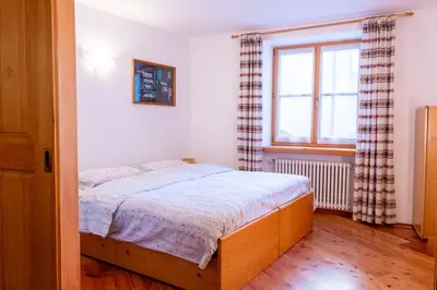 a bedroom with a bed and a window at Casa Rita Roen - Ruffrè-Mendola in Ronzone