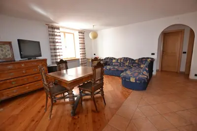 a living room with a table and a couch at Casa Rita Roen - Ruffrè-Mendola in Ronzone
