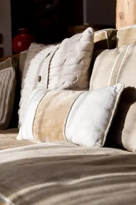a close up of a bed with white pillows at Awakening in the Dolomites between Pelmo and Antelao in Borca di Cadore