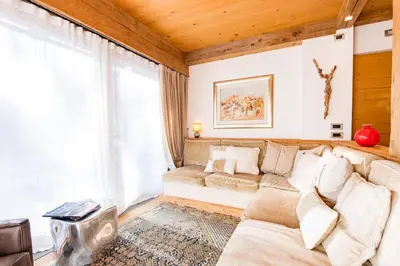 a living room with a couch and a large window at Awakening in the Dolomites between Pelmo and Antelao in Borca di Cadore
