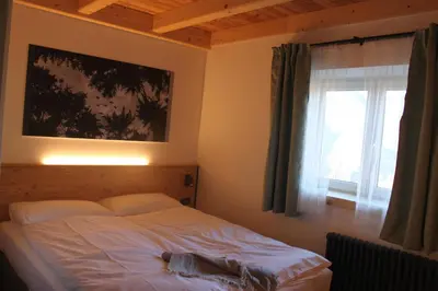 a bed in a bedroom with a window at Mas dal Vent in Valfloriana