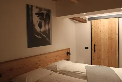 a bedroom with a bed and a picture on the wall at Mas dal Vent in Valfloriana
