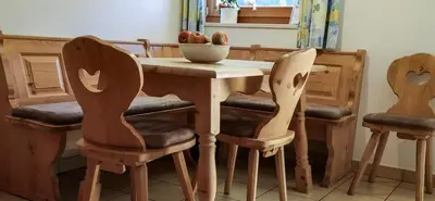 a table with two chairs and a bowl of fruit on it at Ferienwohnung Matzhof in Nova Levante