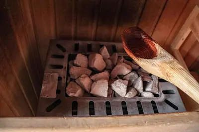 a wooden spoon and some rocks in a box at Ferienwohnung Matzhof in Nova Levante