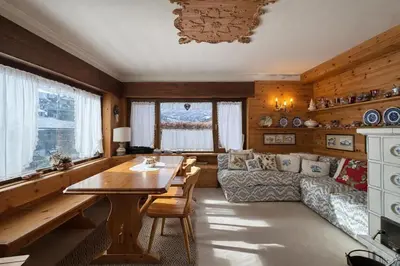 a living room with a table and a couch at Ca La Casetta in Cortina dʼAmpezzo
