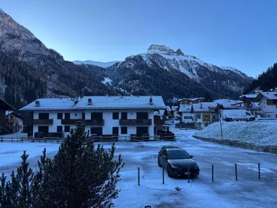 a car parked in a parking lot in front of houses at Casa a Penia-Alba a 2 minuti da impianti funivia in Penia