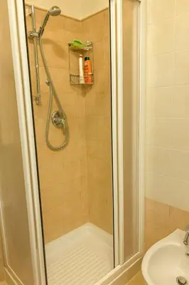 a shower with a glass door in a bathroom at Casa a Penia-Alba a 2 minuti da impianti funivia in Penia