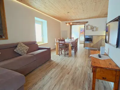 a living room with a couch and a table at La Perla di Fassa - Alpine Stay Apartments in Moena