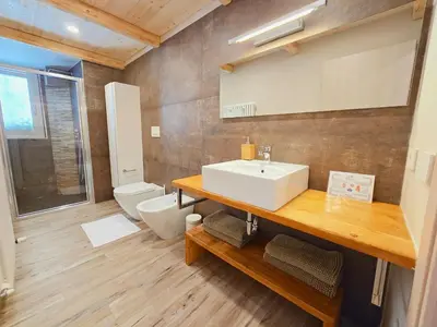 a bathroom with a sink and a toilet at La Perla di Fassa - Alpine Stay Apartments in Moena