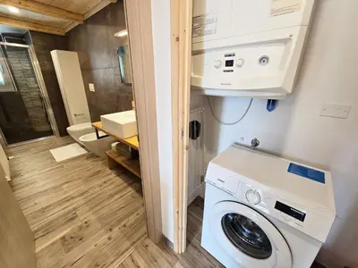 a washer and dryer in a tiny house at La Perla di Fassa - Alpine Stay Apartments in Moena