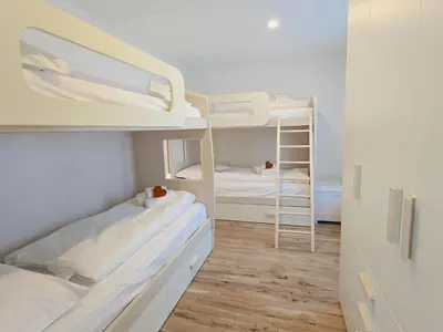 a small room with two bunk beds in it at La Perla di Fassa - Alpine Stay Apartments in Moena