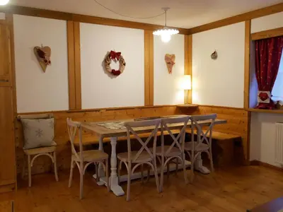 a dining room with a table and chairs at Appartamento Val Di Roda in San Martino di Castrozza