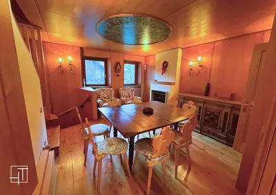a dining room with a table and chairs and a fireplace at HT - Esclusivo chalet a Cortina d'Ampezzo in Cortina dʼAmpezzo