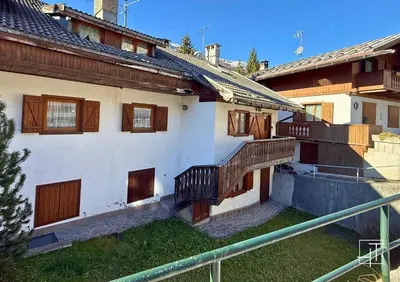 a building with wooden balconies on the side of it at HT - Esclusivo chalet a Cortina d'Ampezzo in Cortina dʼAmpezzo