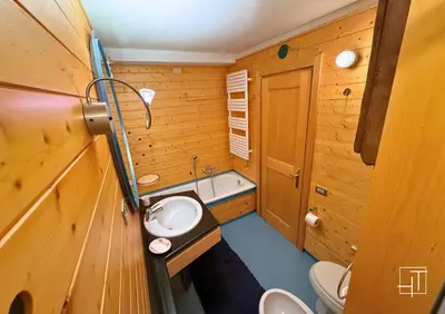a small bathroom with a sink and a toilet at HT - Esclusivo chalet a Cortina d'Ampezzo in Cortina dʼAmpezzo