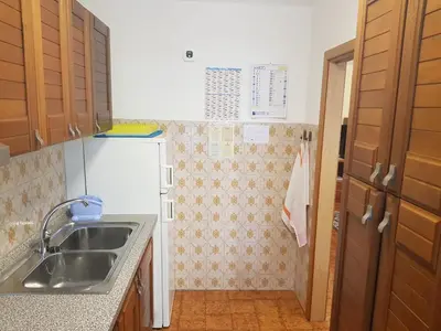 a small kitchen with a sink and a refrigerator at Appartamento Rosa in Predazzo