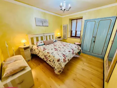 a bedroom with a bed and a chair in it at Trilli House in Rocca Pietore