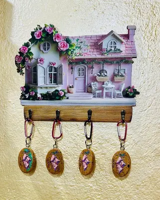 a toy doll house with charms hanging on a wall at Trilli House in Rocca Pietore
