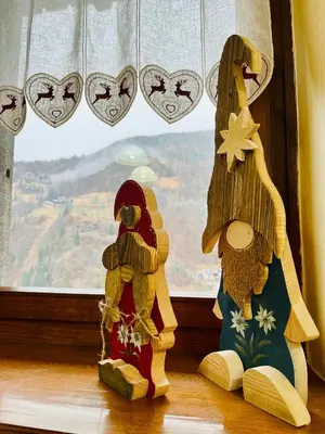 two stuffed animals sitting in front of a window at Trilli House in Rocca Pietore