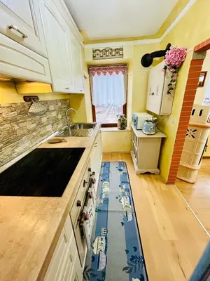 a kitchen with a drain in the floor in a kitchen at Trilli House in Rocca Pietore