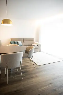 a living room with a table and a couch at Trutscher Häusl in Villnöss - Chalet in den Dolomiten mit Blick auf die Geisler in Funes