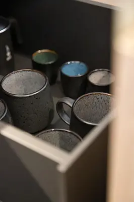 a group of coffee cups sitting on a counter at Trutscher Häusl in Villnöss - Chalet in den Dolomiten mit Blick auf die Geisler in Funes